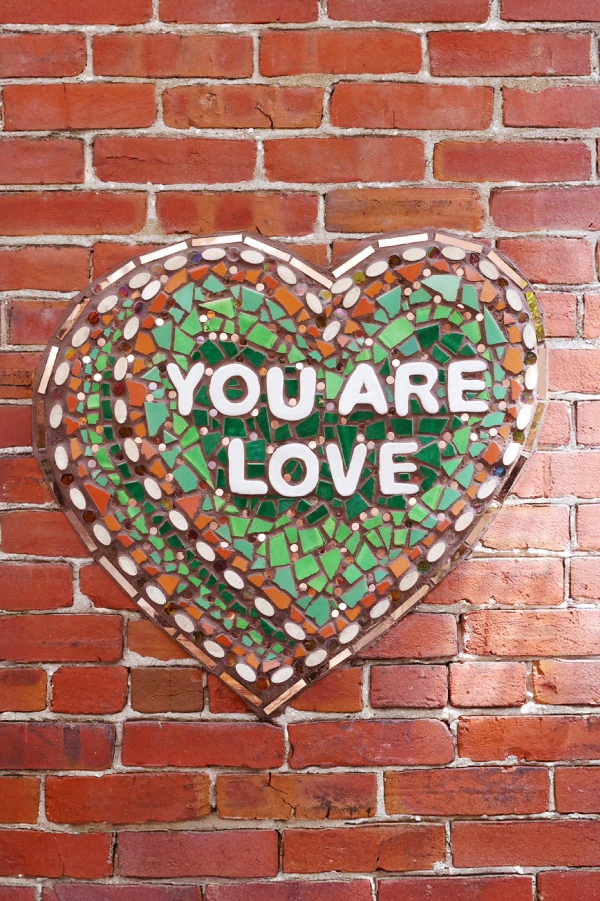 The &lsquo;You Are Love&rsquo; mosaic heart on The Patio&rsquo;s brick wall